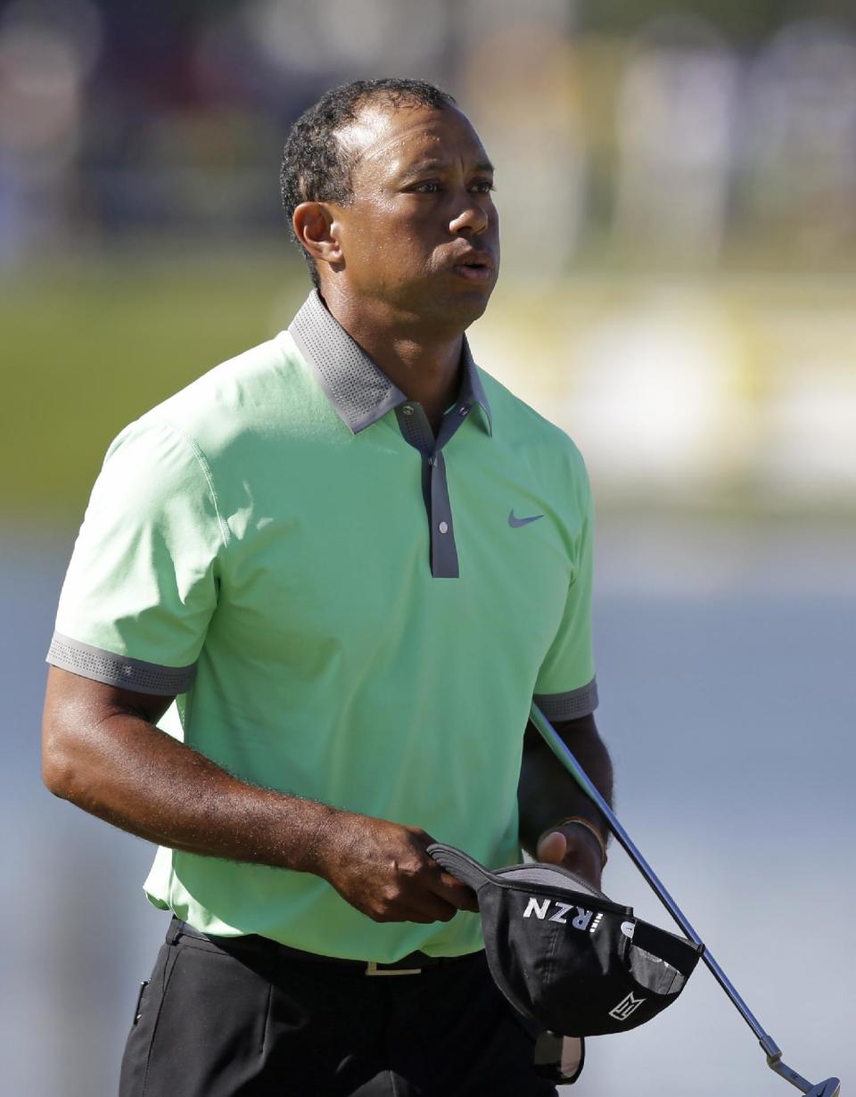 Tiger Woods exhales at the end of the third round of the Cadillac Championship golf tournament Saturday, March 8, 2014, in Doral, Fla. (AP Photo/Wilfredo Lee)