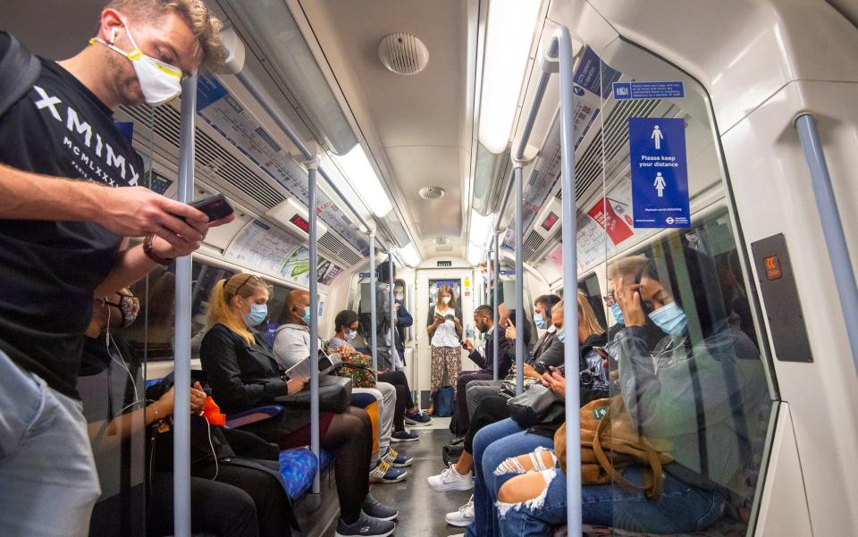 Passengers wearing face masks on the Jubilee Line in London - Victoria Jones/PA Wire