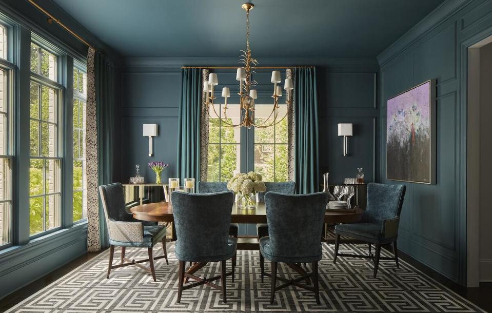 The designer cloaked a paneled dining room and its furnishings in a rich teal hue