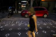 A woman walks along a street in Athens, Greece June 27, 2015. REUTERS/Marko Djurica