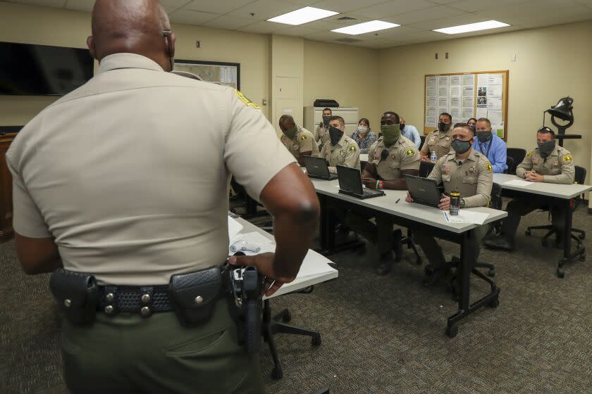 SAN BERNARDINO, CA -JULY27: San Bernardino County Sheriff's Deputy Chief Horace Boatwright, left, speaks at an early morning briefing. San Bernardino Sheriff's Headquarters on Monday, July 27, 2020 in San Bernardino, CA. (Irfan Khan/Los Angeles Times)