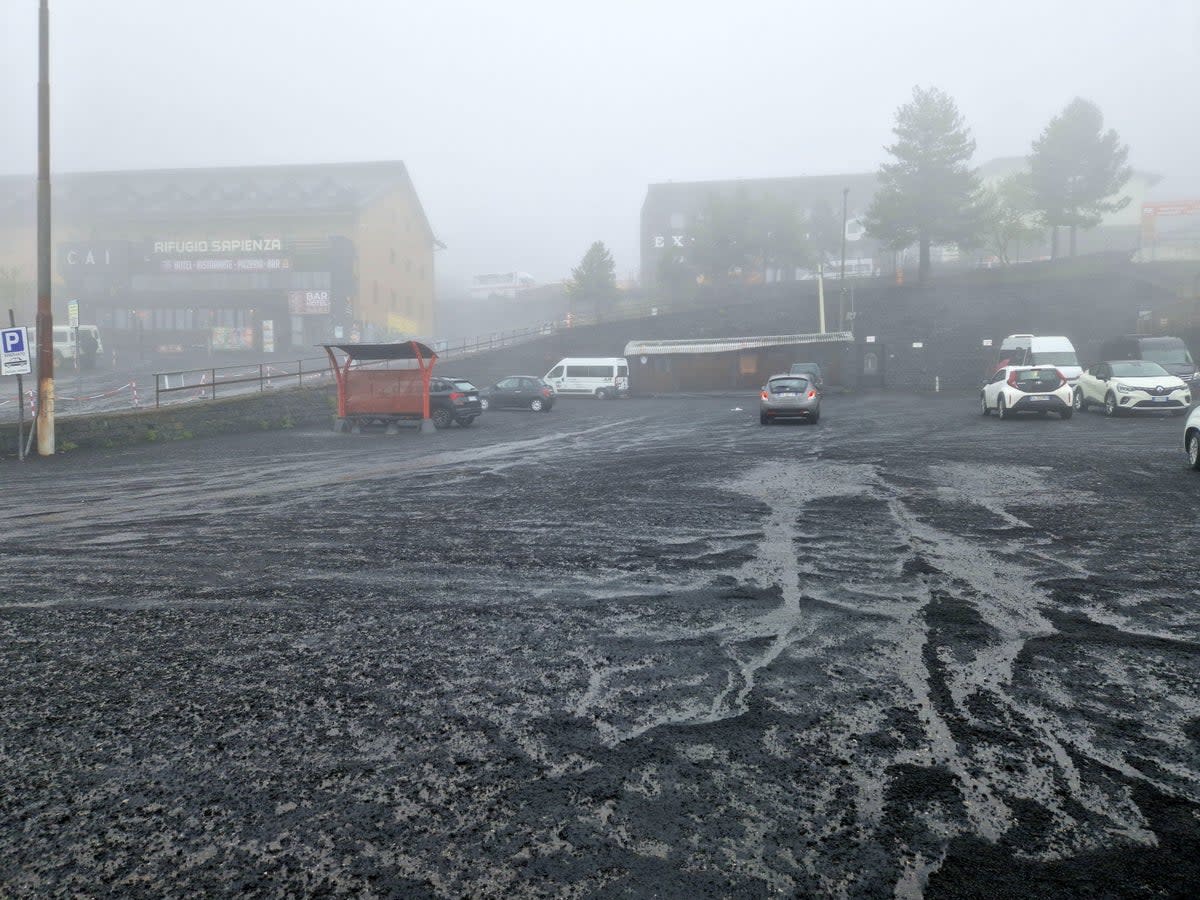 A thick layer of ash coats a public square in Sicily (EPA)