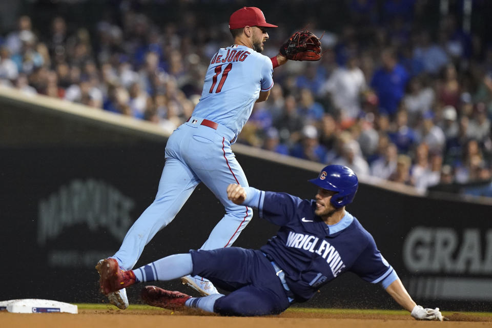 St. Louis Cardinals shortstop Paul DeJong, left, throws out Chicago Cubs' Kris Bryant at first after forcing out Patrick Wisdom during the sixth inning of a baseball game in Chicago, Saturday, June 12, 2021. (AP Photo/Nam Y. Huh)