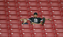 Arizona Cardinals fans watch during an NFL football training camp, Tuesday, July 29, 2014, in Glendale, Ariz. (AP Photo/Matt York)