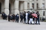 <p>An honor guard, followed by the Georgia Black Caucus, carried Congressman Lewis's casket out of the Georgia State Capitol on the day of Lewis's funeral. </p>