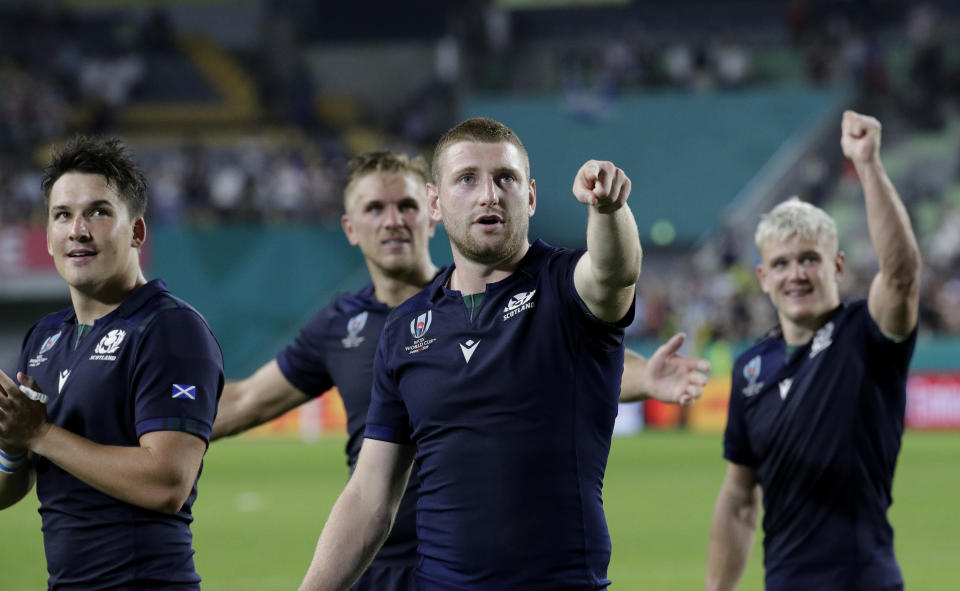 Scotland players wave to the crowd following their Rugby World Cup Pool A game at Kobe Misaki Stadium between Scotland and Samoa in Kobe City, Japan, Monday, Sept. 30, 2019. Scotland defeated Samoa 34-0. (AP Photo/Aaron Favila)