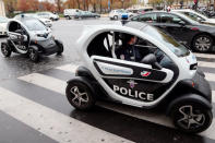 Policemen drive Renault Twizy electric cars in the street on the Trocadero square in Paris.