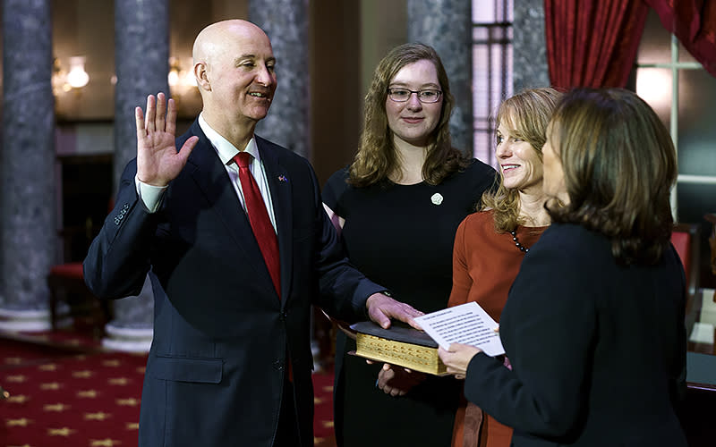 Sen. Pete Ricketts (R-Neb.) participates in a ceremonial photo-op with Vice President Harris after being sworn in on Jan. 23. <em>Greg Nash</em>