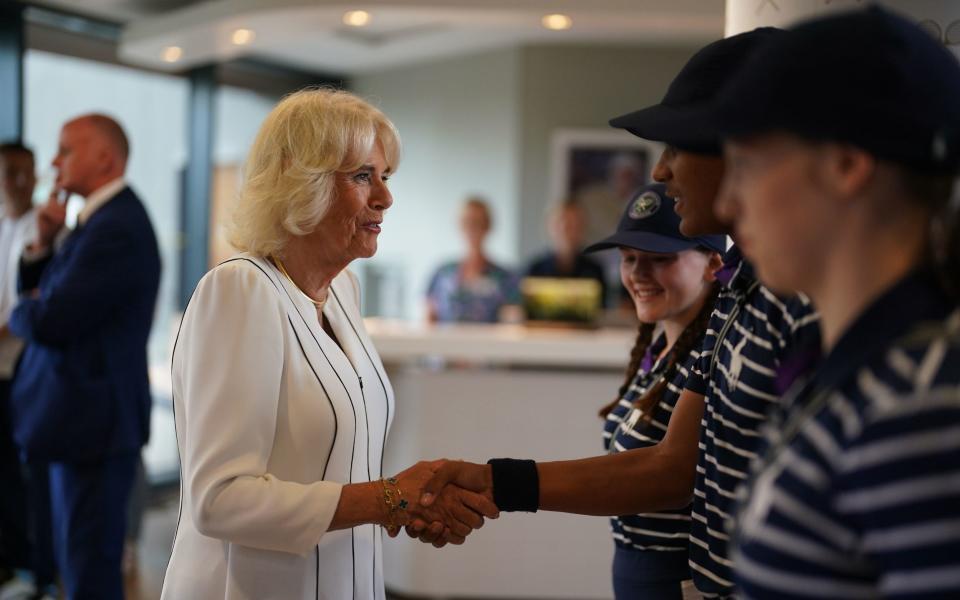 Queen Camilla greeted by the ball boys and girls