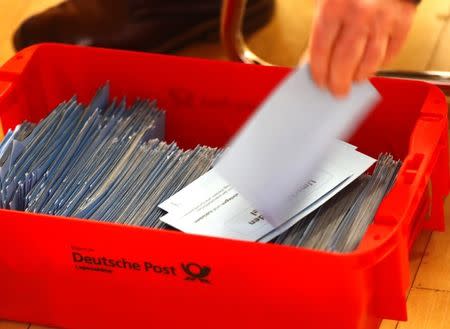 German Social Democratic Party (SPD) member counts ballot papers of the voting for a possible coalition between the Social Democratic Party (SPD) and the Christian Democratic Union (CDU) in the SPD headquarters in Berlin, Germany March 3, 2018. REUTERS/Hannibal Hanschke