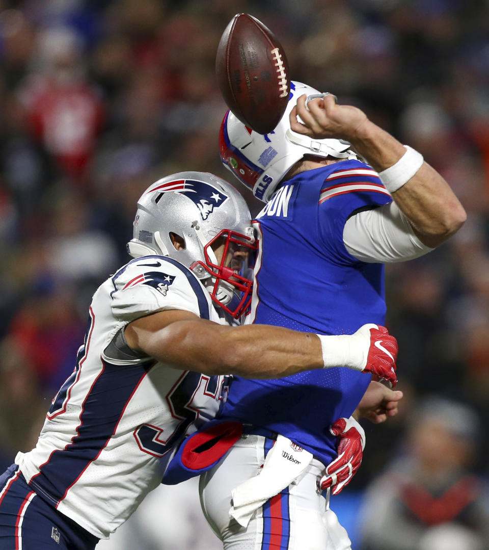 Buffalo Bills quarterback Derek Anderson, right, fumbles the ball on a hit by New England Patriots linebacker Kyle Van Noy during the second half of an NFL football game, Monday, Oct. 29, 2018, in Orchard Park, N.Y. The Patriots recovered the fumble on the play. (AP Photo/Jeffrey T. Barnes)