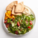 <p>Tomatoes, cucumber, red onion and feta top arugula in this quick Greek-inspired salad. Served with whole-wheat pita and prepared hummus, it makes a filling, yet healthy lunch. <a href="https://www.eatingwell.com/recipe/258521/cucumber-tomato-arugula-salad-with-hummus/" rel="nofollow noopener" target="_blank" data-ylk="slk:View Recipe" class="link ">View Recipe</a></p>