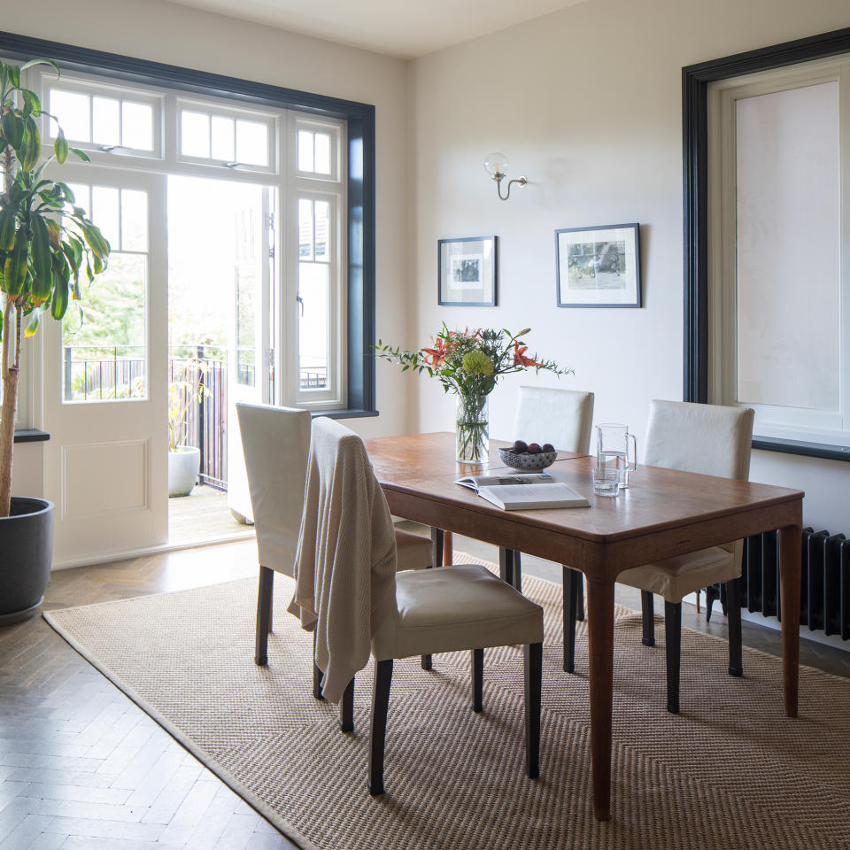 Dining area with wooden table, parquet flooring and french doors to garden