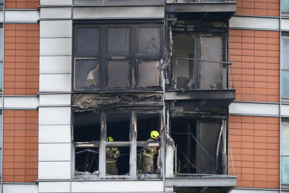 <p>Firefighters inspect damage to a 19-storey tower block in New Providence Wharf in London, where the London Fire Brigade (LFB) was called to on Friday morning to reports of a fire and more than 100 firefighters are tackling a blaze that has ripped through the block, believed to be covered in cladding, in east London. Picture date: Friday May 7, 2021. See PA story FIRE CanaryWharf. Photo credit should read: Yui Mok/PA</p>
