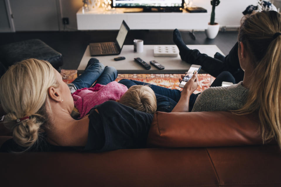 mum and daughters watching tv