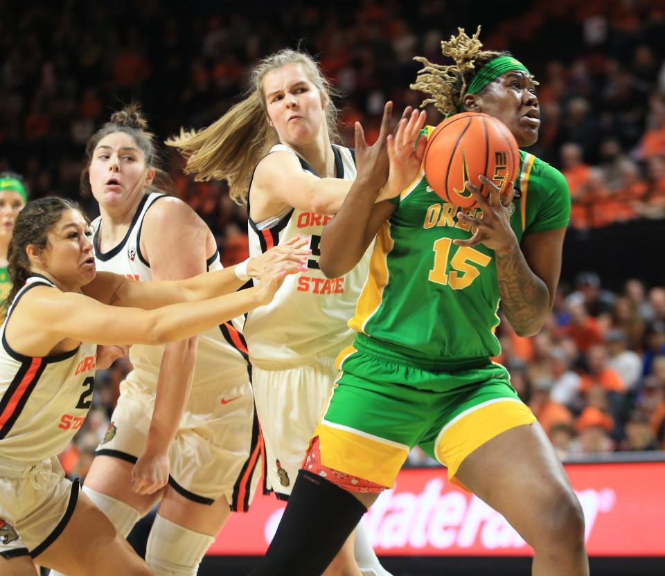 Oregon’s Phillipina Kyei, right, goes to the basket under pressure from Oregon State’s Kelsey Rees during the first half in Corvallis Sunday, Dec. 31, 2023.