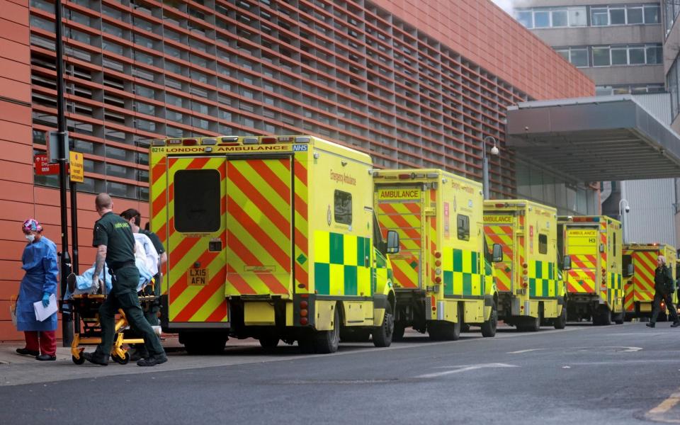 Medics transport a patient from an ambulance to the Royal London Hospital as the spread of the coronavirus disease (COVID-19) continues - HANNAH MCKAY/Reuters