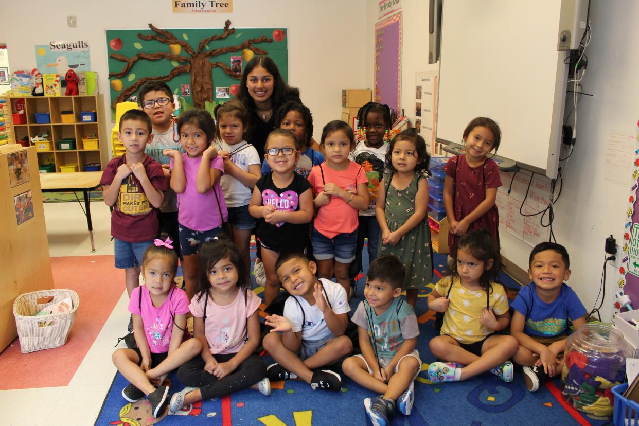 Students in Guadalupe Center’s Seagulls class smile after receiving a set of 10 new children’s books and backpacks provided by BelieveNBooks.