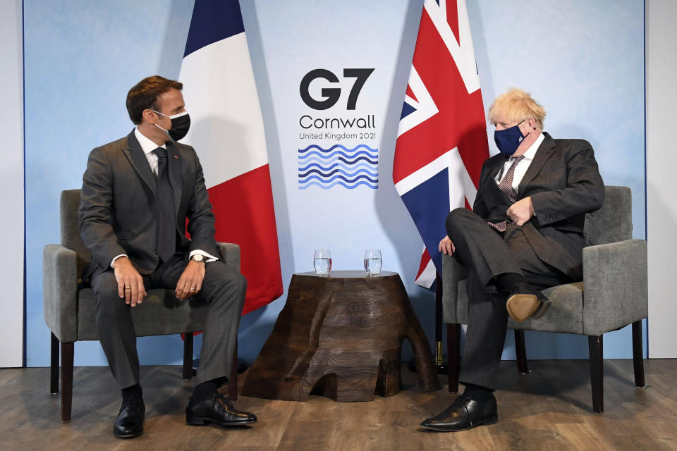 Britain's Prime Minister Boris Johnson, right, and French President Emmanuel Macron ahead of a bilateral meeting during the G7 summit in Cornwall, England, Saturday June 12, 2021. (Stefan Rousseau/Pool via AP)