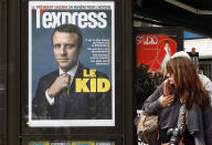<p>A woman looks toward a poster of the front cover of L’Express, with the picture of the newly elected French President Emmanuel Macron, in Paris, May 8, 2017. Macron defeated far-right leader Marine Le Pen in Sunday’s presidential vote. (Chesnot/Getty Images) </p>