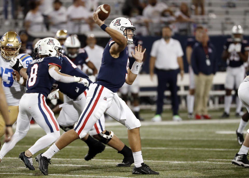 Arizona quarterback Gunner Cruz (9) throws during the second half of an NCAA college football game against UCLA Saturday, Oct. 9, 2021, in Tucson, Ariz. (AP Photo/Chris Coduto)