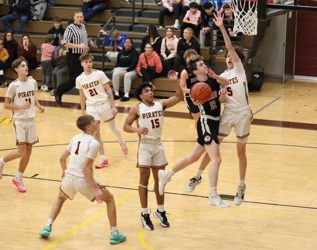 New Boston Huron's Kyle Kantola goes to the basket during a 56-54 win over Riverview Tuesday night.