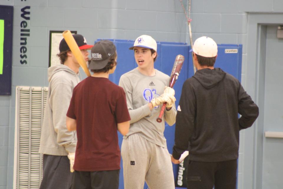 Oyster River head baseball coach Cam Calato, right, talks with John Federico, Andy Carlson and Jack Poitras during Thursday's practice.