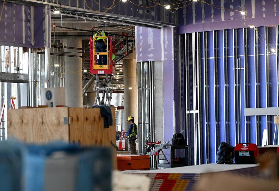 Workers at Mote SEA during a media tour of the ongoing construction on Friday, April 5, 2024.