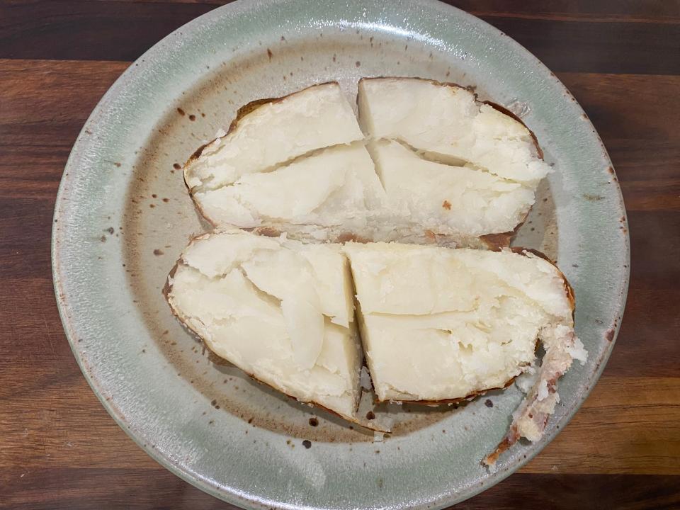 one hour baked potato cut in half and in quarters