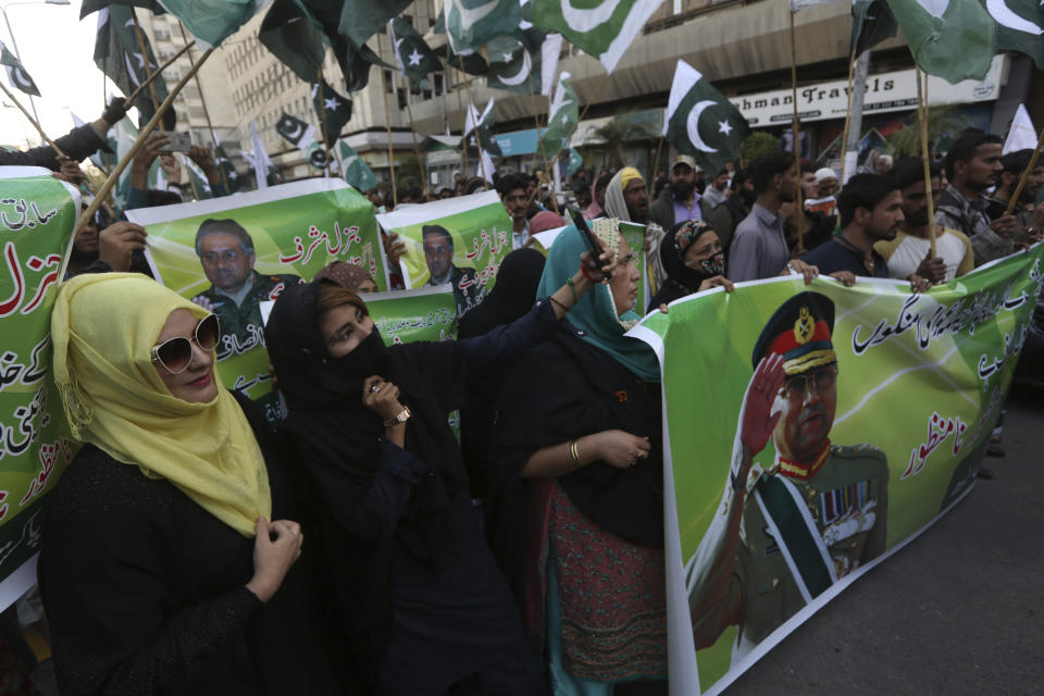 Supporters of former Pakistani military ruler Gen. Pervez Musharraf protest a court's decision, in Karachi, Pakistan, Wednesday, Dec. 18, 2019. The Pakistani court sentenced Musharraf to death in a treason case related to the state of emergency he imposed in 2007 while in power, officials said. Musharraf who is apparently sick and receiving treatment in Dubai where he lives was not present in the courtroom. (AP Photo/Fareed Khan)