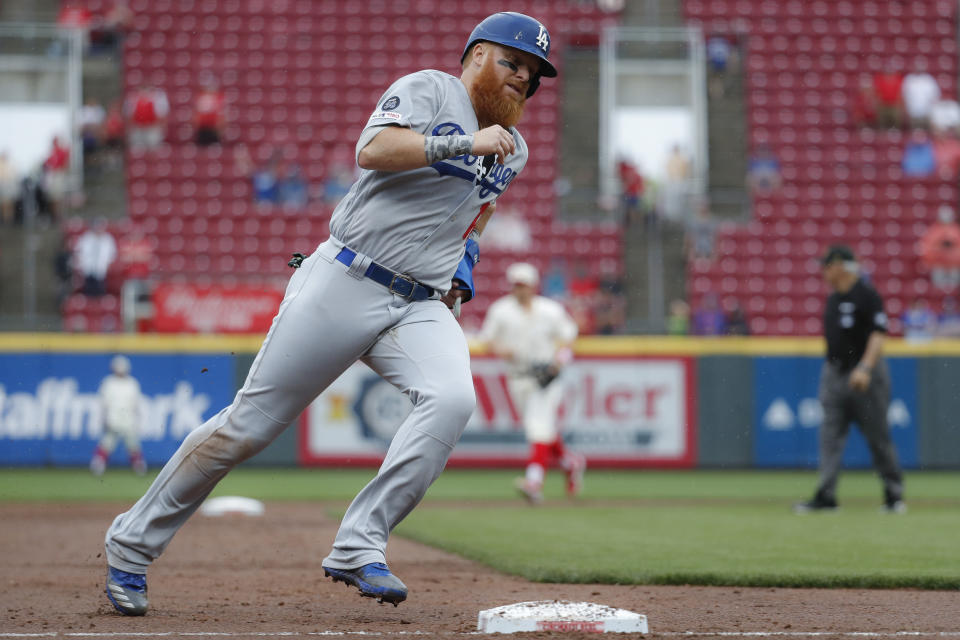 Los Angeles Dodgers' Justin Turner runs home to score on a two-run double by Alex Verdugo off Cincinnati Reds relief pitcher Robert Stephenson in the ninth inning of a baseball game, Sunday, May 19, 2019, in Cincinnati. (AP Photo/John Minchillo)