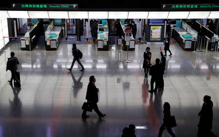 FILE PHOTO: Passengers are seen in front of security check at the Tokyo International Airport, commonly known as Haneda Airport, in Tokyo, Japan January 10, 2018. REUTERS/Toru Hanai/File Photo