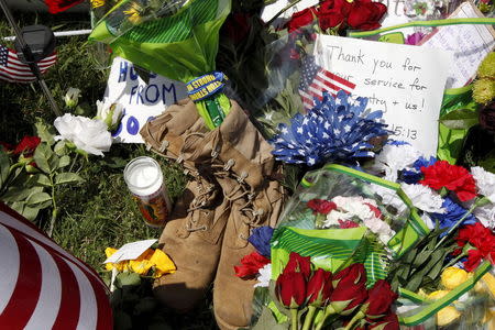 Items left at a memorial at the Armed Forces Career Center are seen in Chattanooga, Tennessee July 17, 2015. REUTERS/Tami Chappell