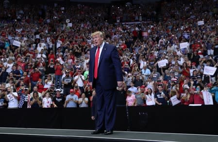 U.S. President Donald Trump reacts with supporters during a campaign rally in Cincinnati