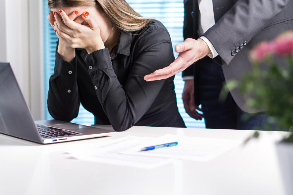 Upset woman crying in office. Getting fired from job. Business man or boss apologizing, comforting or supporting assistant. Businesswoman hurt her feelings or made mistake. Bad leadership or news