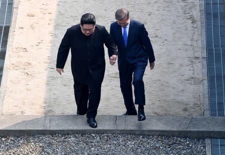 South Korean President Moon Jae-in and North Korean leader Kim Jong Un meet in the truce village of Panmunjom inside the demilitarized zone separating the two Koreas, South Korea, April 27, 2018. Korea Summit Press Pool/Pool via Reuters