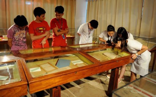 Students view the restored hand-written novels, the original editions, of national hero Jose Rizal's books "Noli Me Tangere" (Touch Me Not) and "El Filibusterismo" (Reign of Greed) at the National Library in Manila in June 2011. Tropical conditions and the library's threadbare budget are big obstacles to saving them for future generations