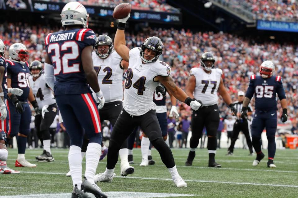 Baltimore Ravens tight end Josh Oliver (84) celebrates his touchdown as New England Patriots safety Devin McCourty (32) looks on in the second half of an NFL football game, Sunday, Sept. 25, 2022, in Foxborough, Mass.