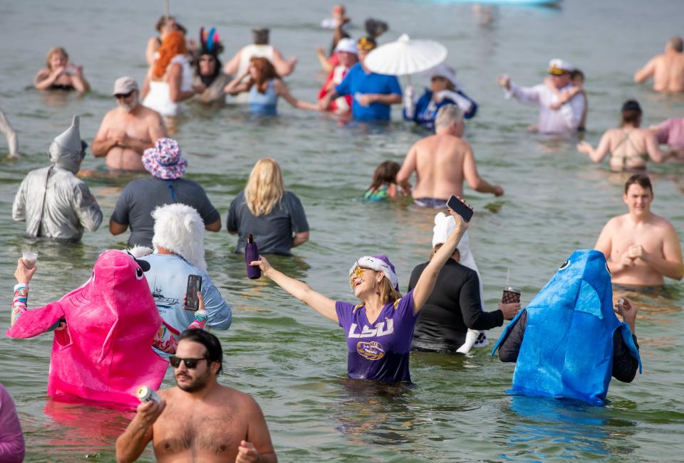 Participants take to the chilly water of Santa Rosa Sound during the Pensacola Polar Bear Plunge at Paradise Bar & Grill Sunday, January 1, 2023.