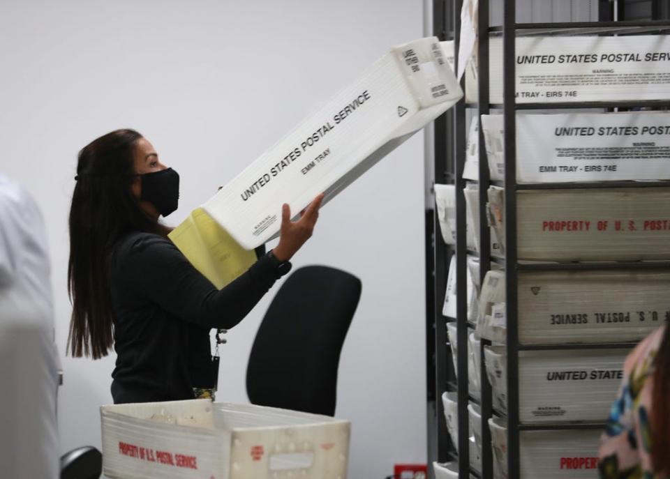 Workers at the Miami-Dade County Elections Department work on tabulating the mail in ballots on primary election day on August 18, 2020 in Doral, Florida. The upcoming election has raised concerns in some quarters about tampering with mail-in ballots.