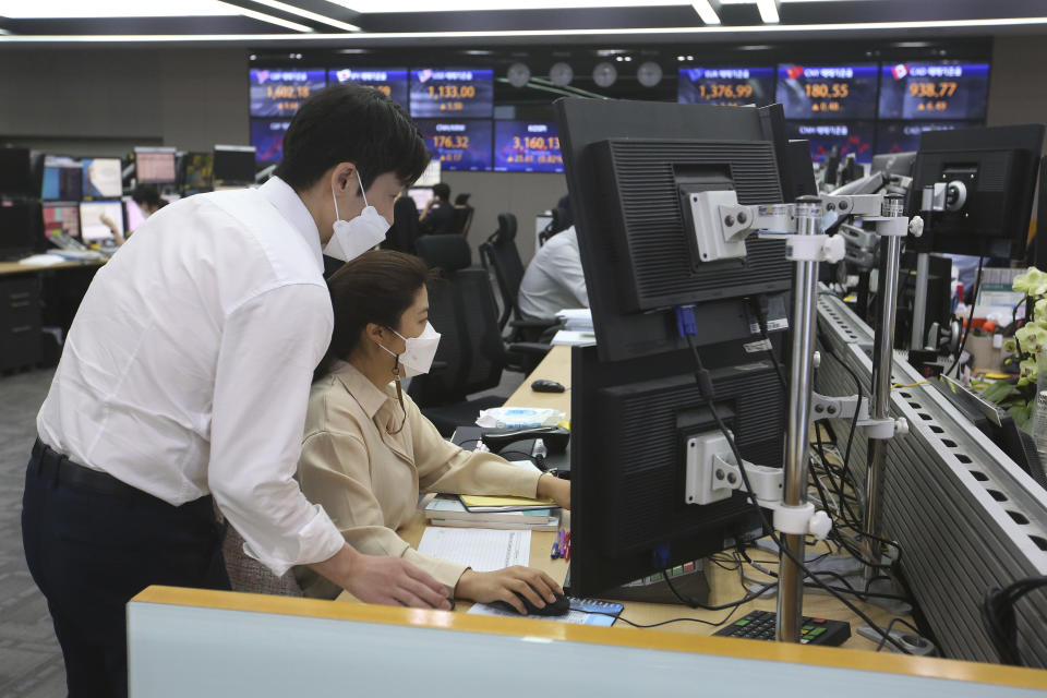Currency traders watch monitors at the foreign exchange dealing room of the KEB Hana Bank headquarters in Seoul, South Korea, Tuesday, May 18, 2021. Asian shares rose Tuesday, partly on bargain-hunting from the recent global market falls amid continuing pessimism about the coronavirus pandemic. (AP Photo/Ahn Young-joon)