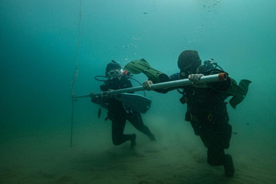 Divers with Indiana University's Center for Underwater Science set a buoy in Lake Michigan to mark the shipwreck site of the Muskegon in summer 2021.