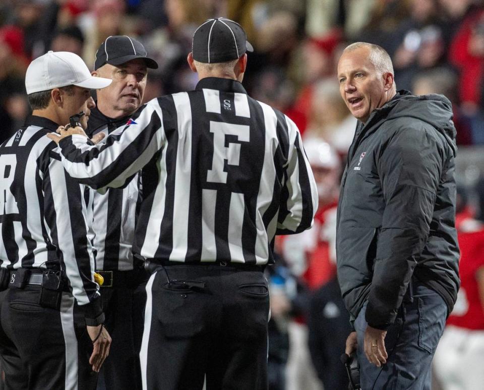 N.C. State coach Dave Doeren questions the officials on a pass interference call in the first quarter against North Carolina on Saturday, November 25, 2023 at Carter-Finley Stadium in Raleigh, N.C.