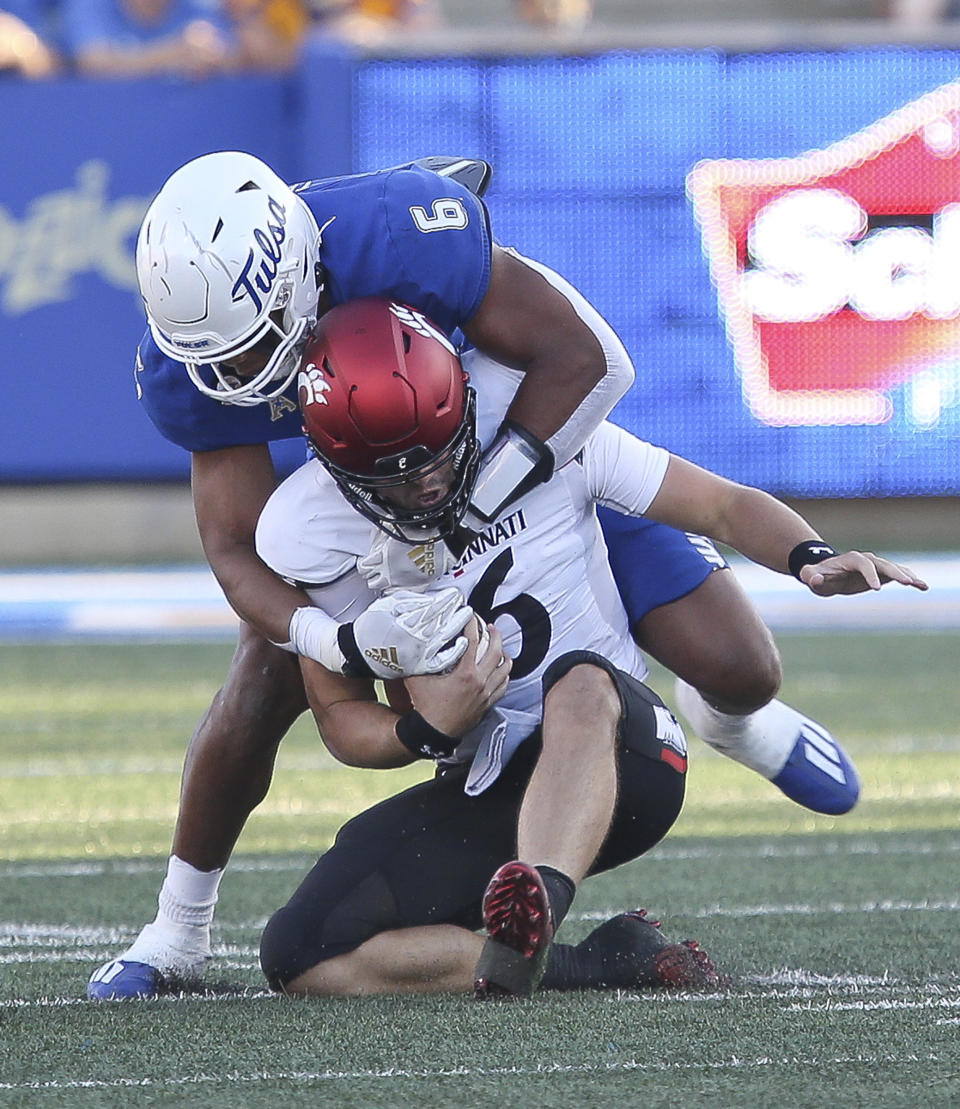 Tulsa's Jon-Michael Terry sacks Cincinnati quarterback Ben Bryant during the first half of an NCAA college football game in Tulsa, Okla., Saturday, Oct. 1, 2022. (AP Photo/Dave Crenshaw)