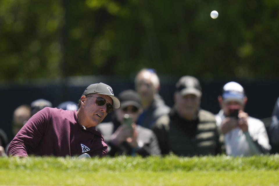 Phil Mickelson hits from the bunker on the second hole during a practice round for the PGA Championship golf tournament at Oak Hill Country Club on Wednesday, May 17, 2023, in Pittsford, N.Y. (AP Photo/Seth Wenig)