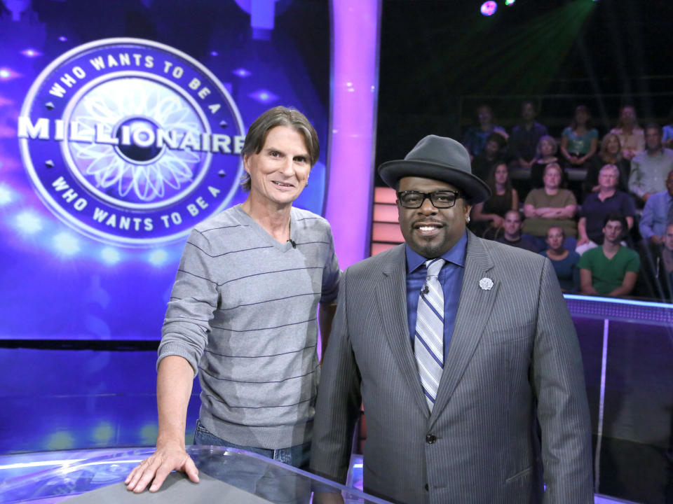 This Aug. 16, 2013, photo provided by Disney-ABC Domestic TV shows Associated Press writer Frazier Moore, left, with host Cedric "The Entertainer" during a test show of the game show "Who Wants To Be A Millionaire" in New York. On Sept. 2, the new season premieres, ushering in Cedric "The Entertainer" as host. (AP Photo/ Disney-ABC Domestic Television, Heidi Gutman)