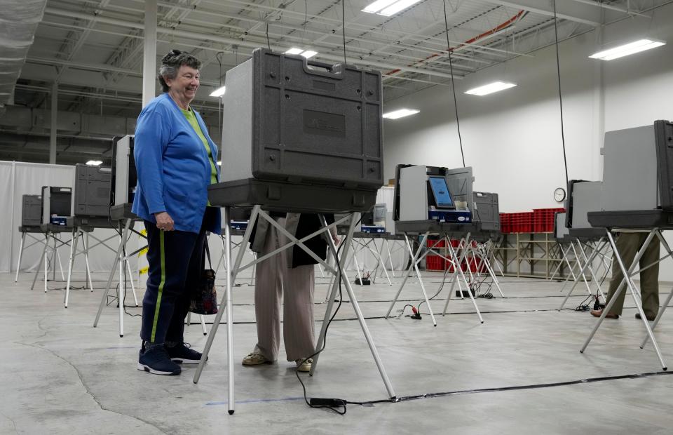 A poll worker assists a voter during early voting for the May primary at the Delaware County Board of Elections.