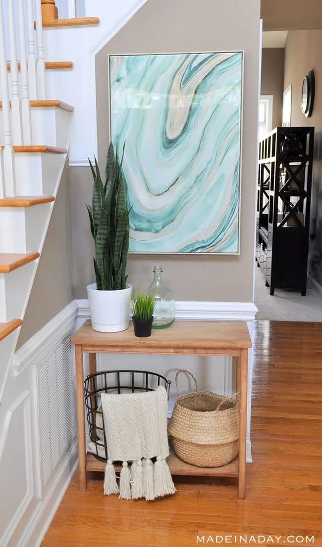 a table with a basket and a painting on it