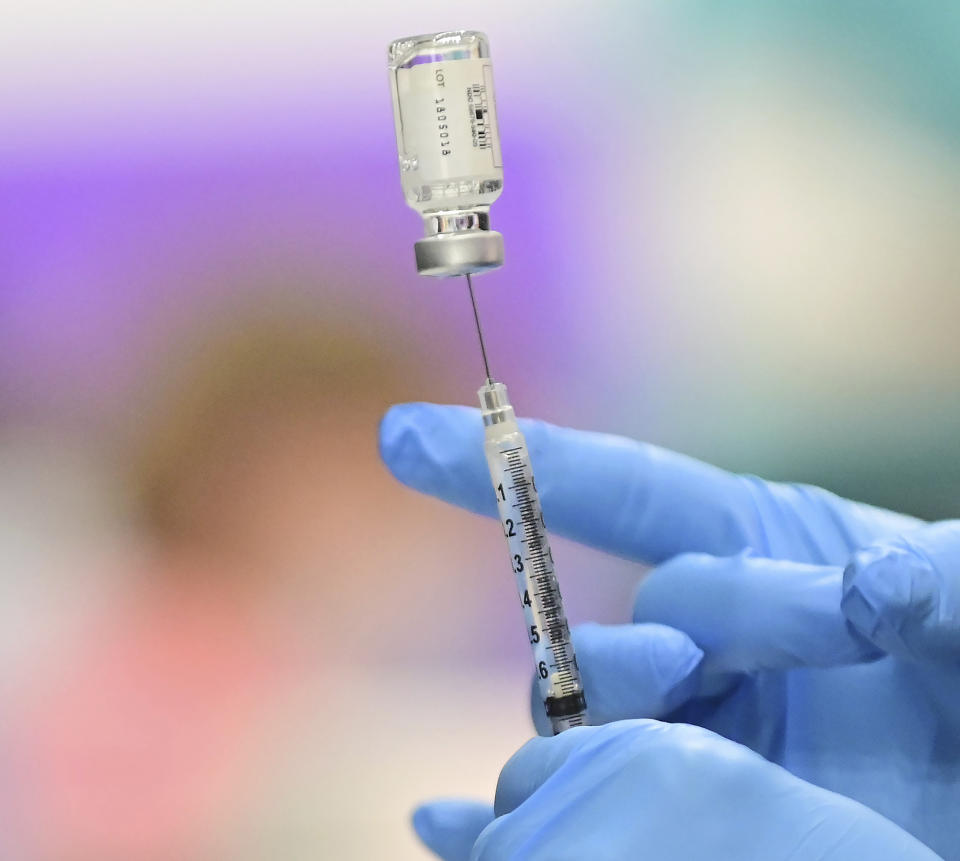 A nurse prepares a dose of COVID-19 vaccination at the Twin Cities Orthopedics Performance Center during COVID-19 vaccinations in Eagan, Minn., on Friday, March 5, 2021. Approximately 13,400 doses of the single-shot Johnson & Johnson vaccine will be administered at the Minnesota Vikings practice facility to health care workers and adults 65 years of age or older over the next few days. (John Autey/Pioneer Press via AP, Pool)