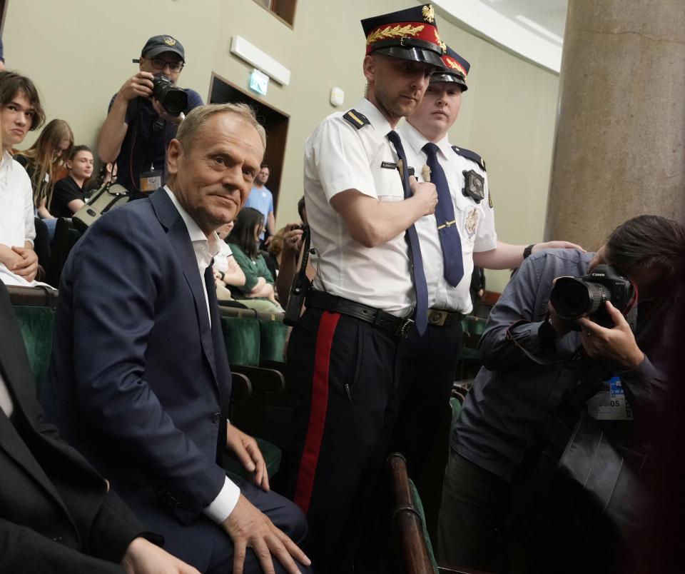 FILE - Poland's opposition leader and former prime minister, Donald Tusk, watches lawmakers vote to approve a contentious draft law in parliament in Warsaw, Poland, on Friday, May 26, 2023. Polish President Andrzej Duda said Monday he will sign a bill that creates a powerful commission, ostensibly meant to investigate Russian influence in Poland but which critics view as a tool to remove from political life the opponents of the ruling party, mostly notably opposition leader Donald Tusk. (AP Photo/Czarek Sokolowski, File)